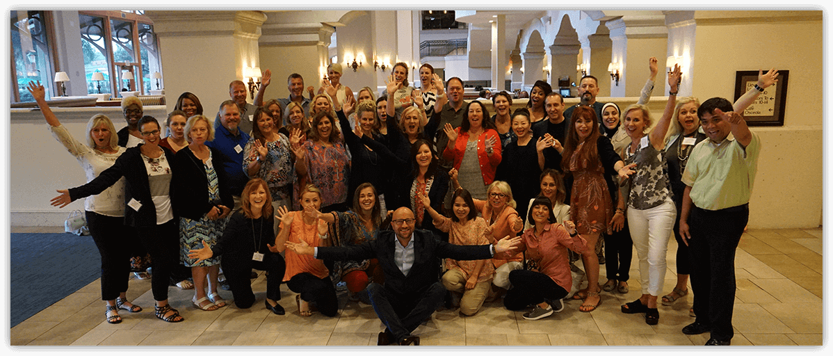 Group image of spa and med spa leaders among Dori, raising their hands high--representing rising to exponentially greater heights.